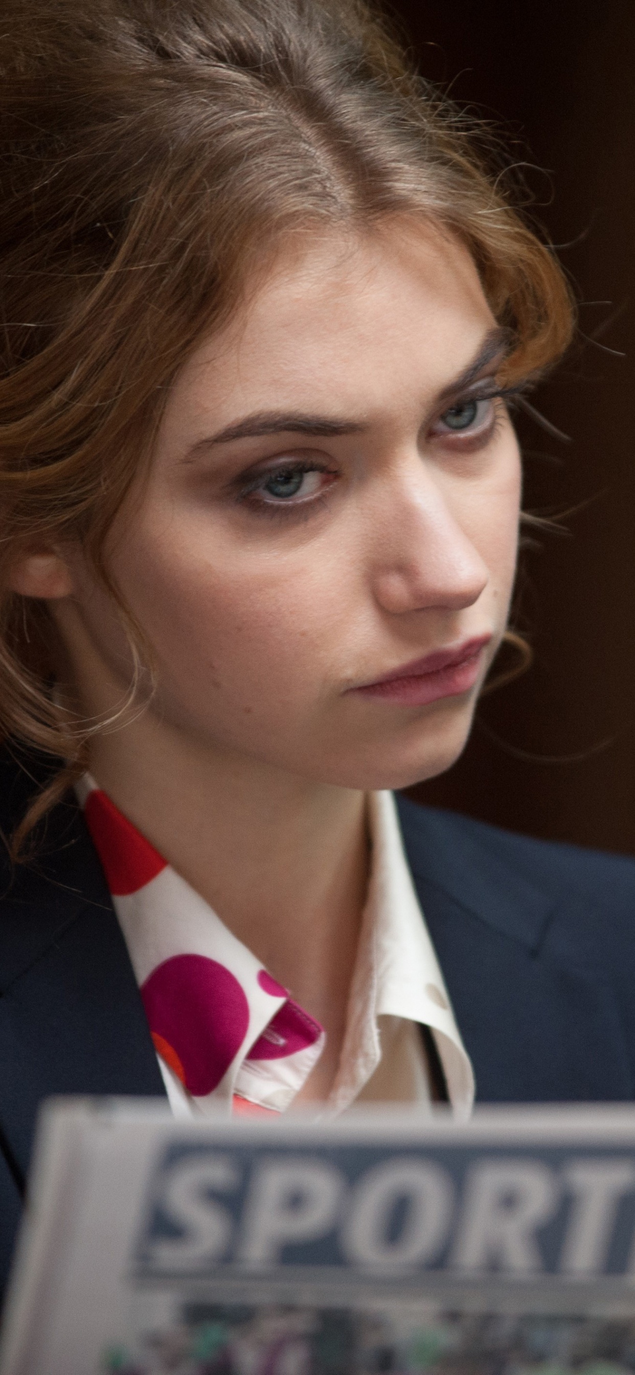 Woman in Black Suit Jacket Holding White and Blue Book. Wallpaper in 1242x2688 Resolution