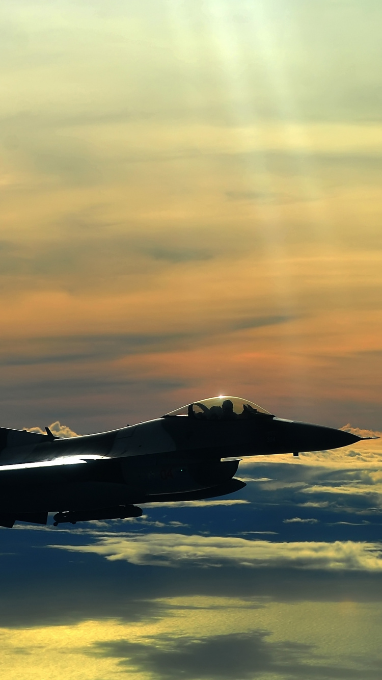 Black Jet Plane Flying Over Clouds During Daytime. Wallpaper in 750x1334 Resolution