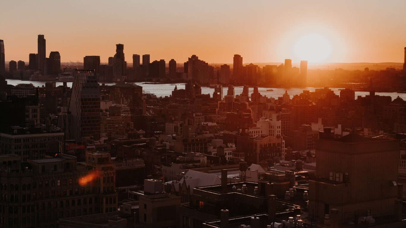 City Skyline During Orange Sunset. Wallpaper in 1366x768 Resolution