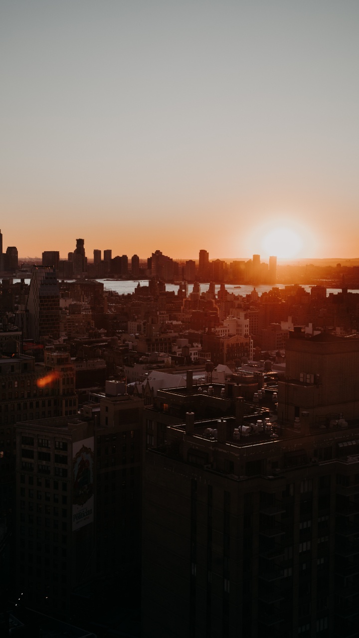 City Skyline During Orange Sunset. Wallpaper in 720x1280 Resolution
