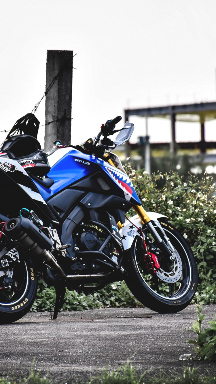 Black and Blue Sports Bike Parked on Gray Concrete Road During Daytime. Wallpaper in 750x1334 Resolution