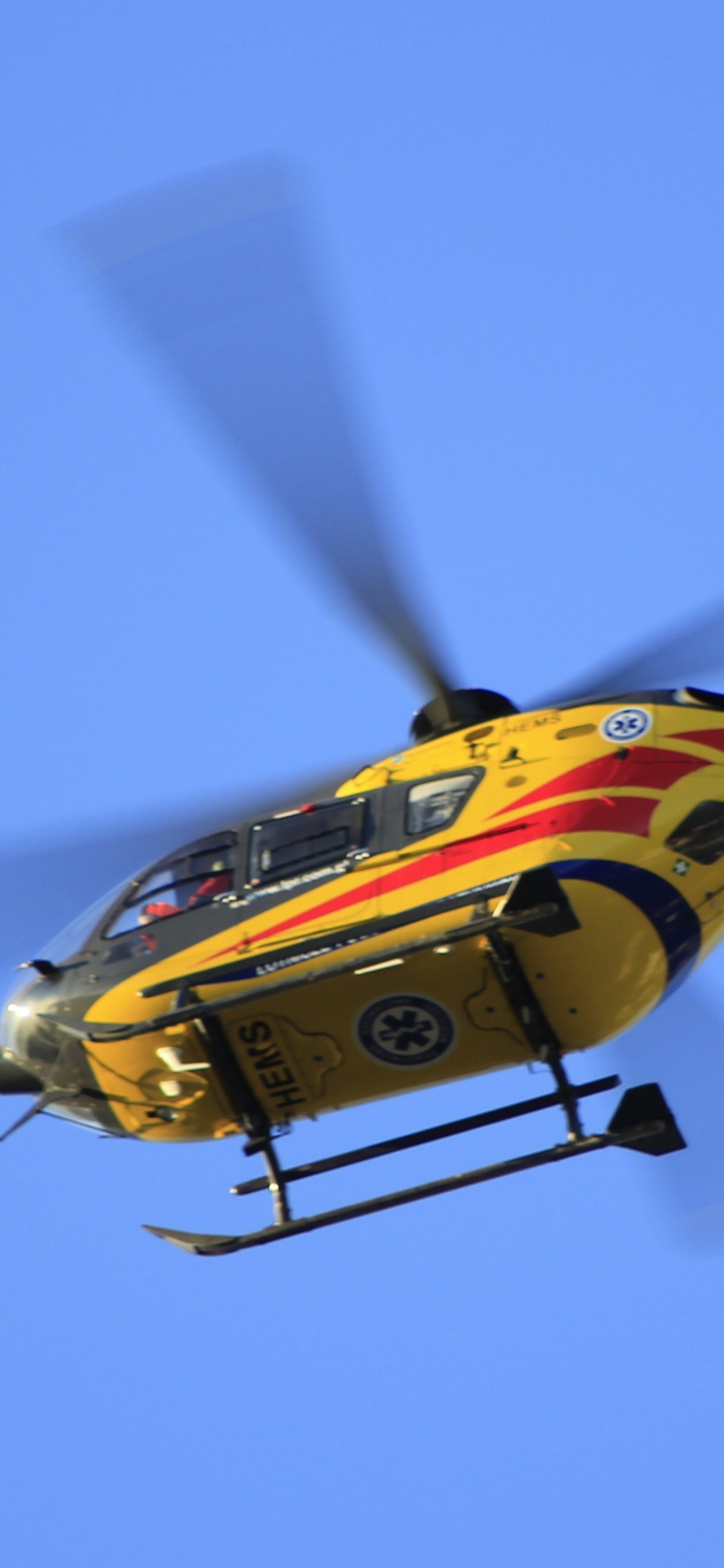 Yellow and Red Helicopter Flying in The Sky. Wallpaper in 1242x2688 Resolution