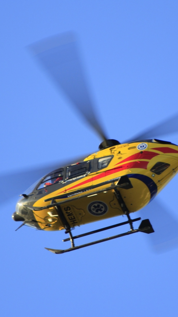 Yellow and Red Helicopter Flying in The Sky. Wallpaper in 720x1280 Resolution