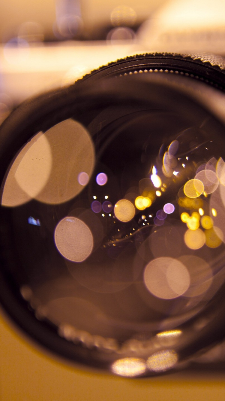 Black Camera Lens With White and Black Round Light. Wallpaper in 750x1334 Resolution