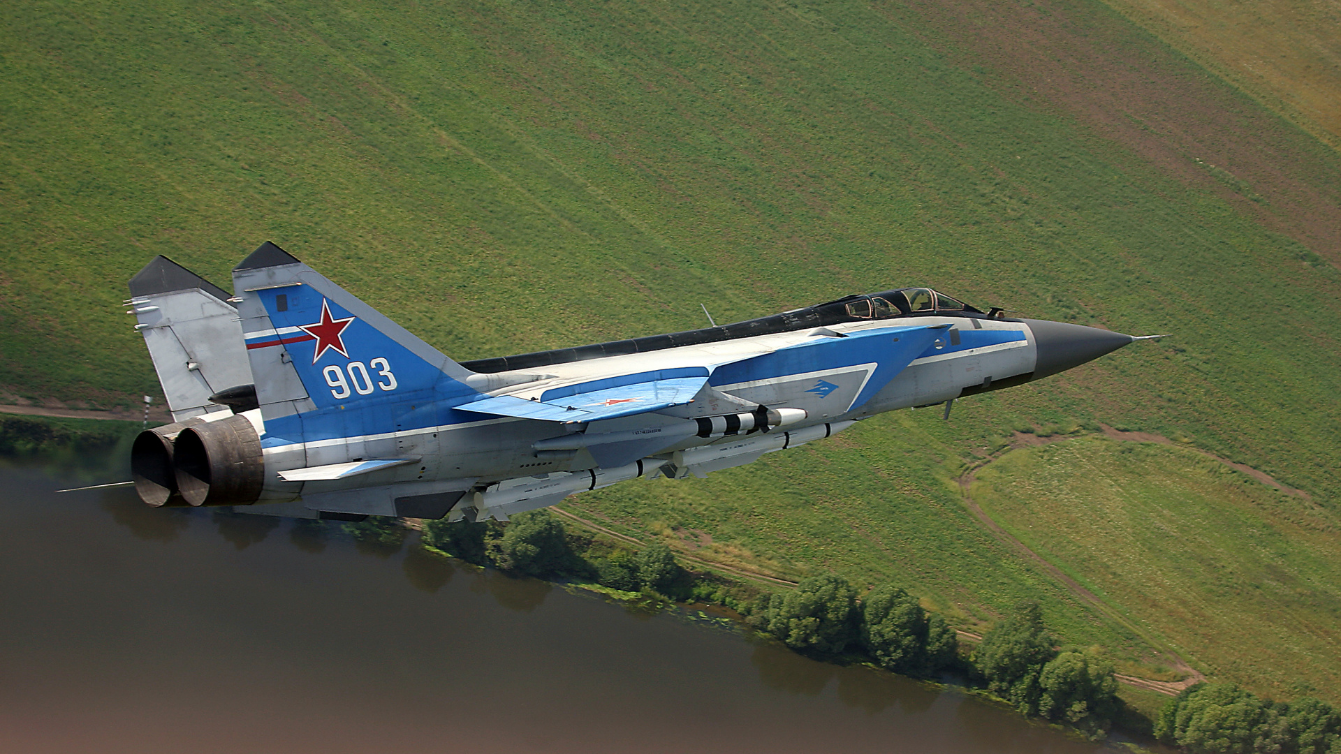 Blue and White Jet Plane Flying Over Green Grass Field During Daytime. Wallpaper in 1920x1080 Resolution