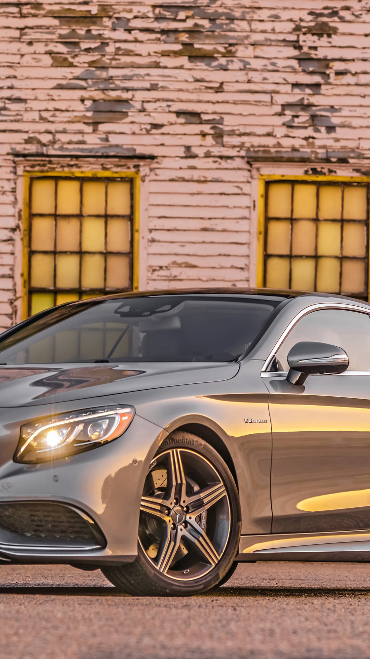 Silver Mercedes Benz Coupe Parked Beside Brown Brick Wall. Wallpaper in 750x1334 Resolution