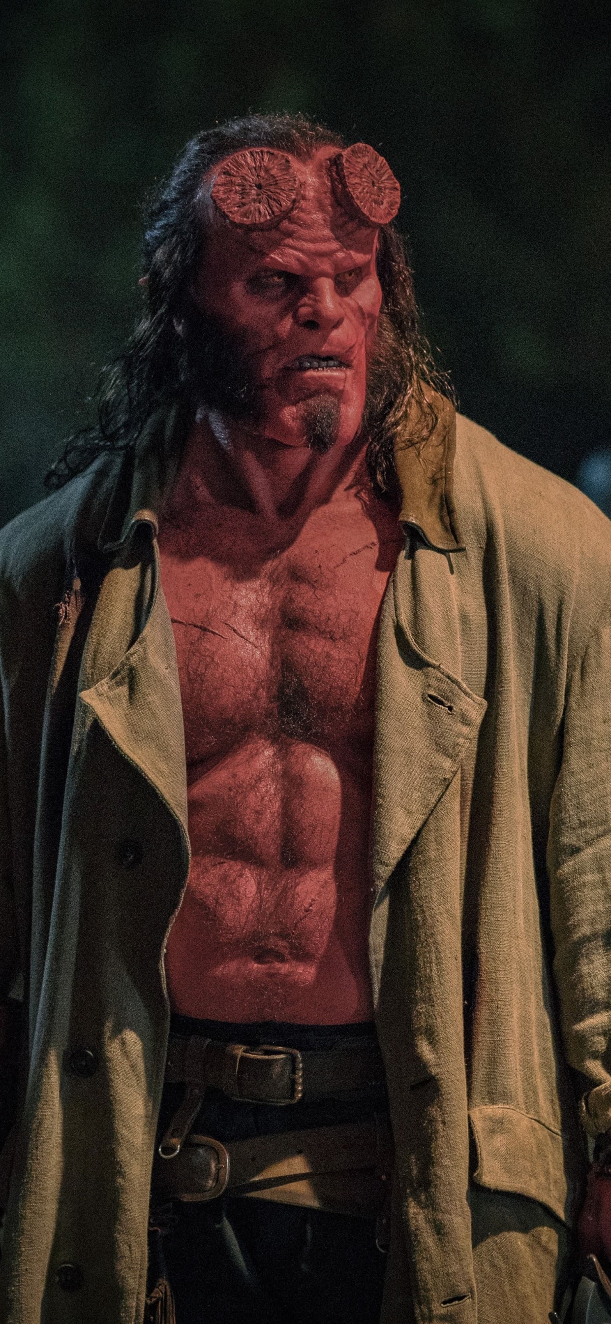 Man in Brown Coat Standing on Green Grass Field During Daytime. Wallpaper in 1242x2688 Resolution