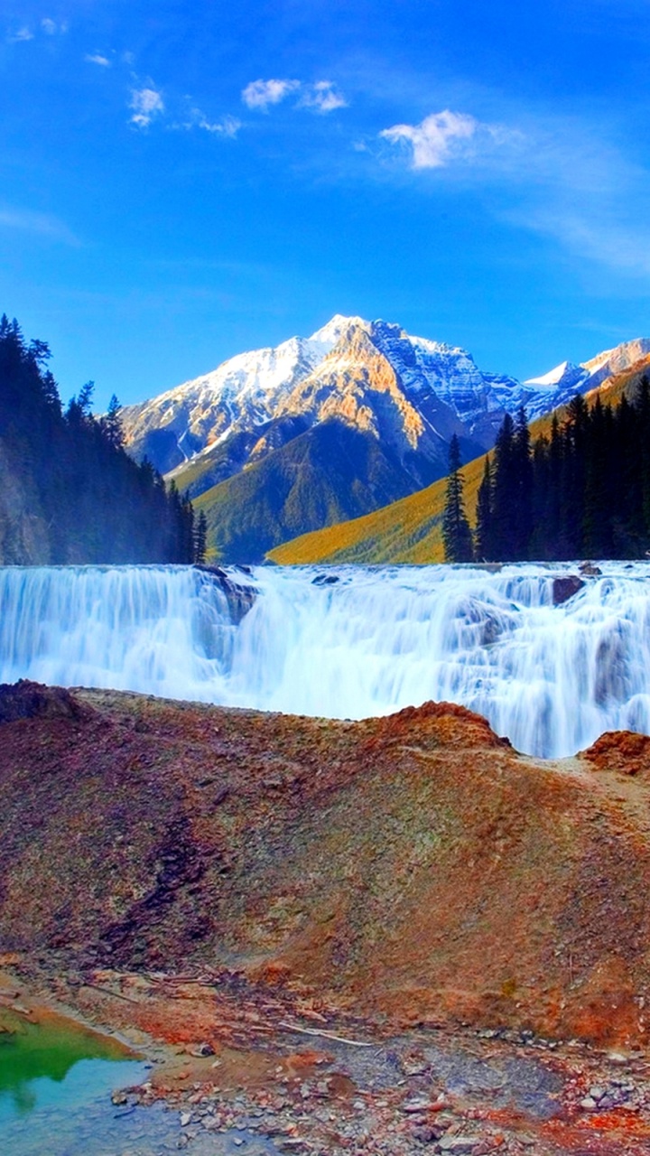 Waterfalls Near Brown and Green Mountain Under Blue Sky During Daytime. Wallpaper in 720x1280 Resolution