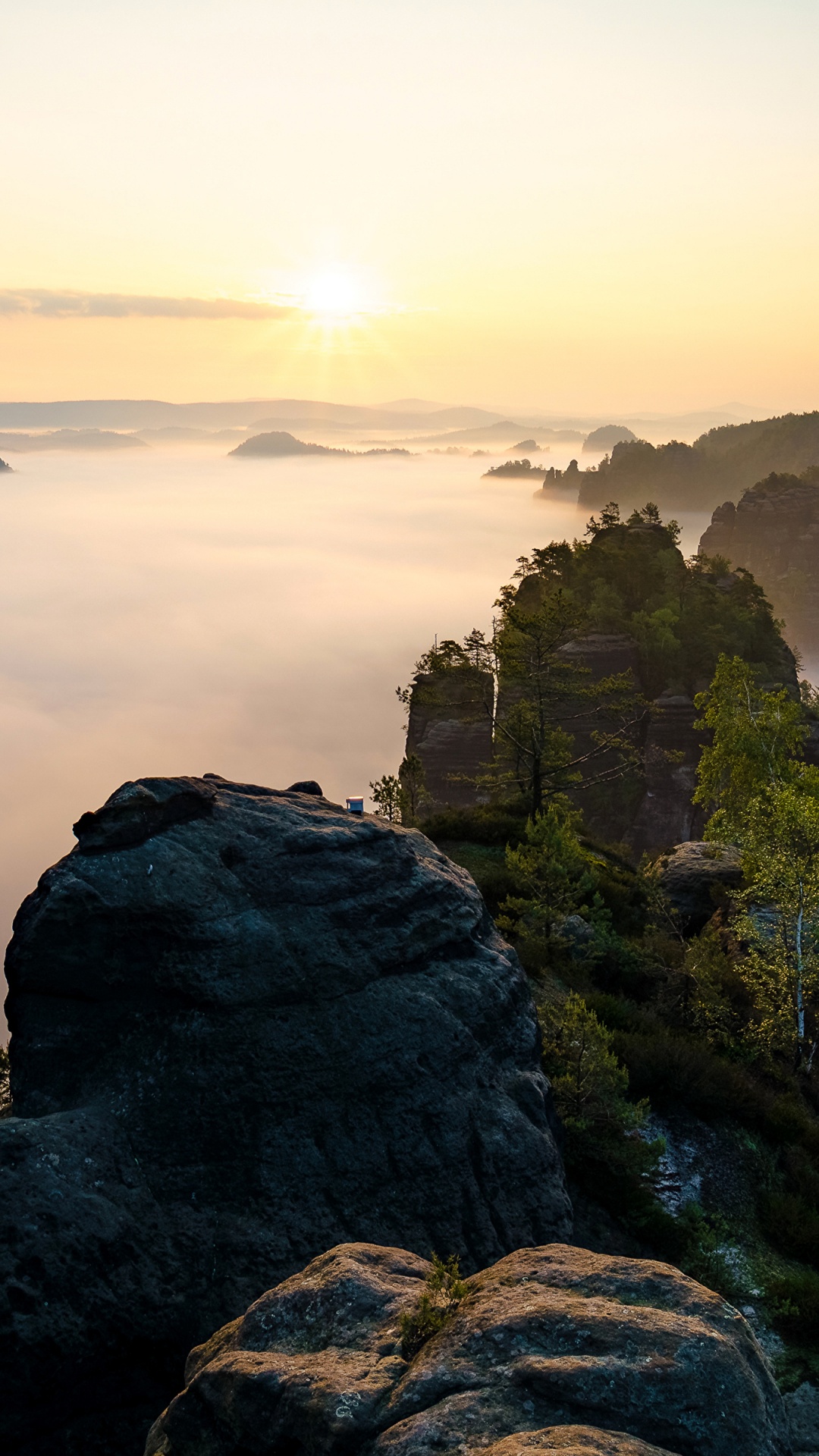 Green and Brown Rock Formation Near Body of Water During Daytime. Wallpaper in 1080x1920 Resolution