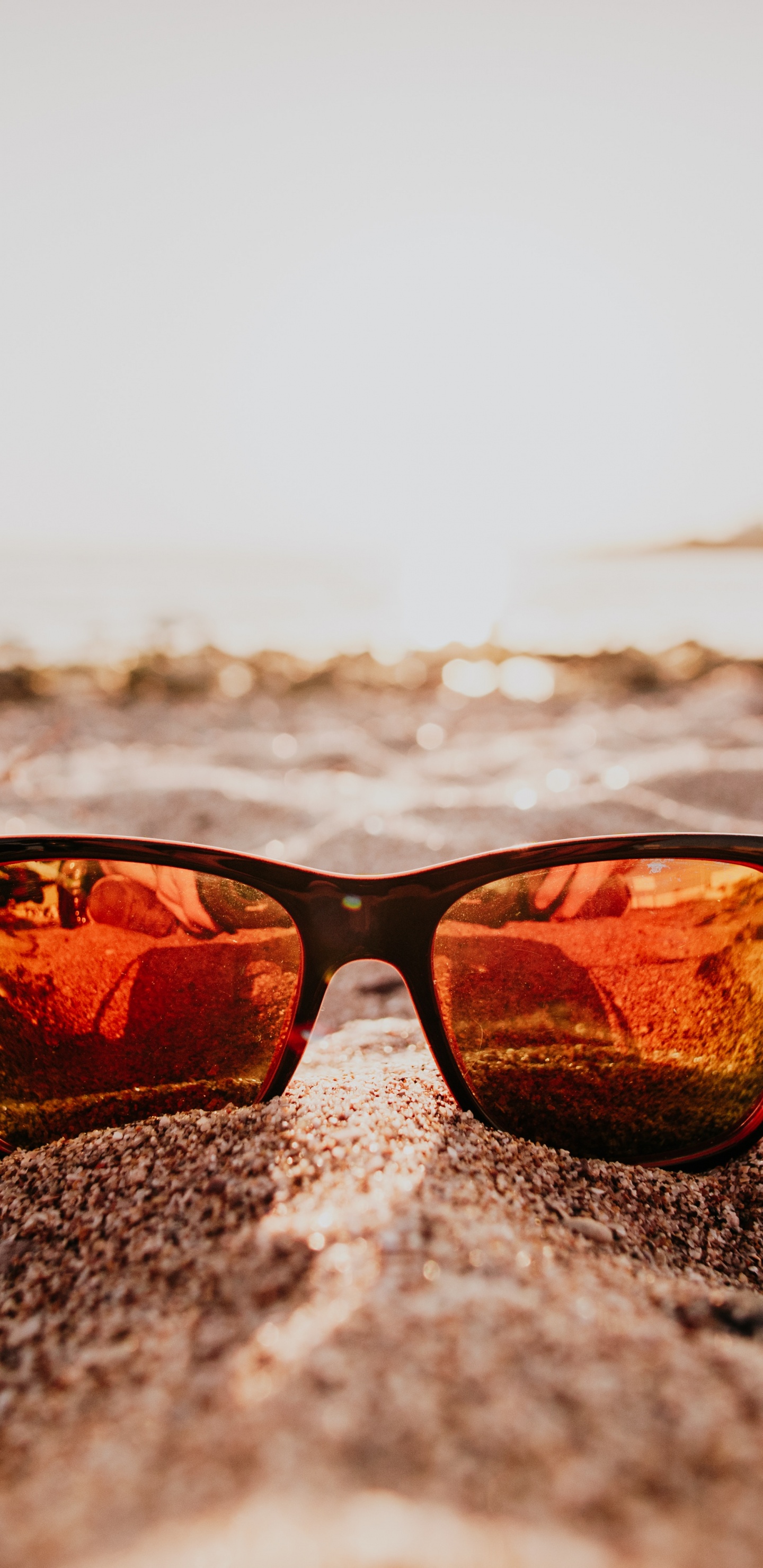 Lunettes de Soleil à Monture Noire Sur la Plage Pendant le Coucher du Soleil. Wallpaper in 1440x2960 Resolution