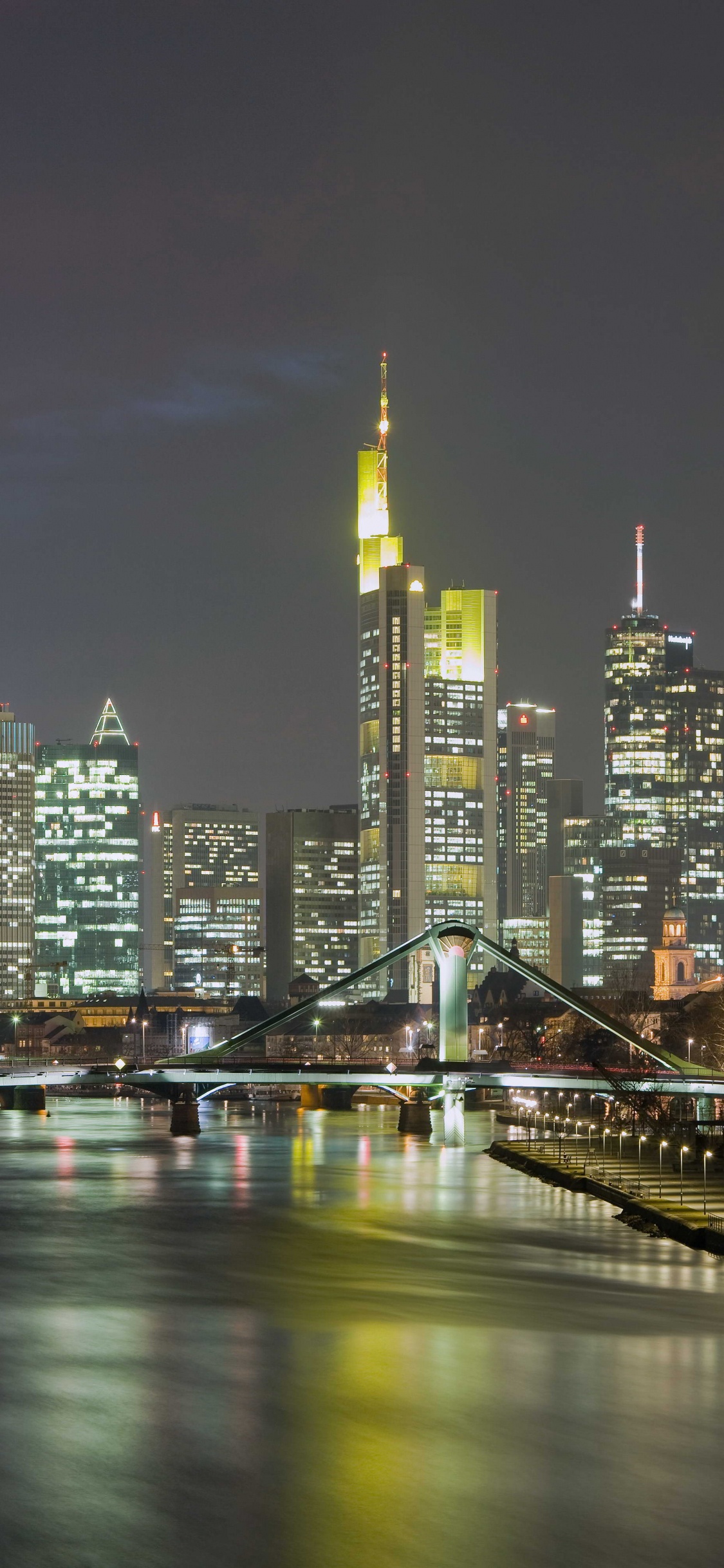 City Skyline During Night Time. Wallpaper in 1125x2436 Resolution