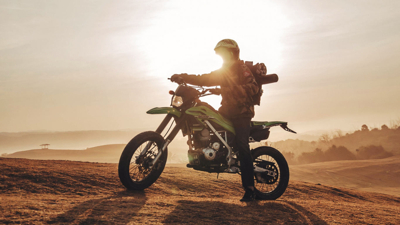 Man Riding Motorcycle on Brown Sand During Daytime. Wallpaper in 1366x768 Resolution