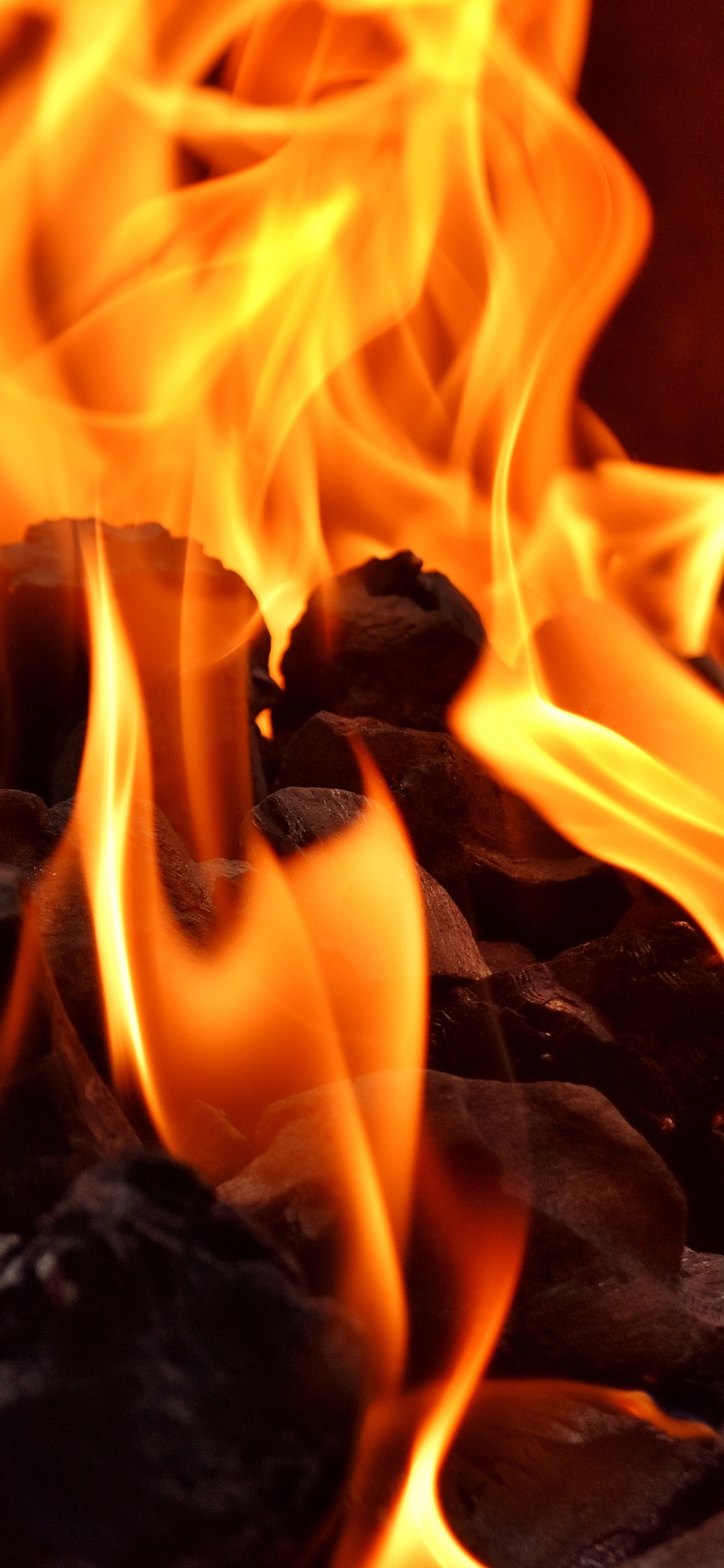 Burning Fire on Black Textile. Wallpaper in 1125x2436 Resolution