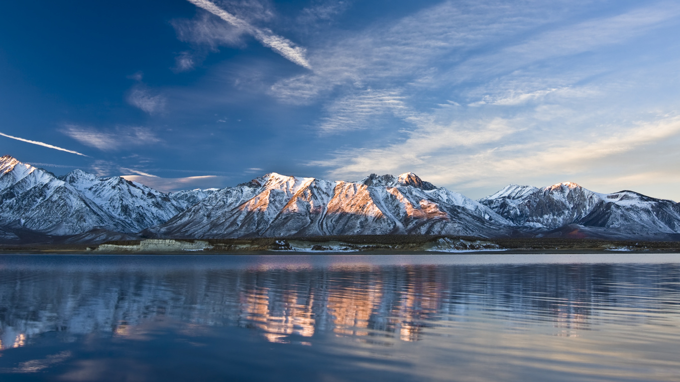 Snow Covered Mountain Near Body of Water During Daytime. Wallpaper in 1366x768 Resolution