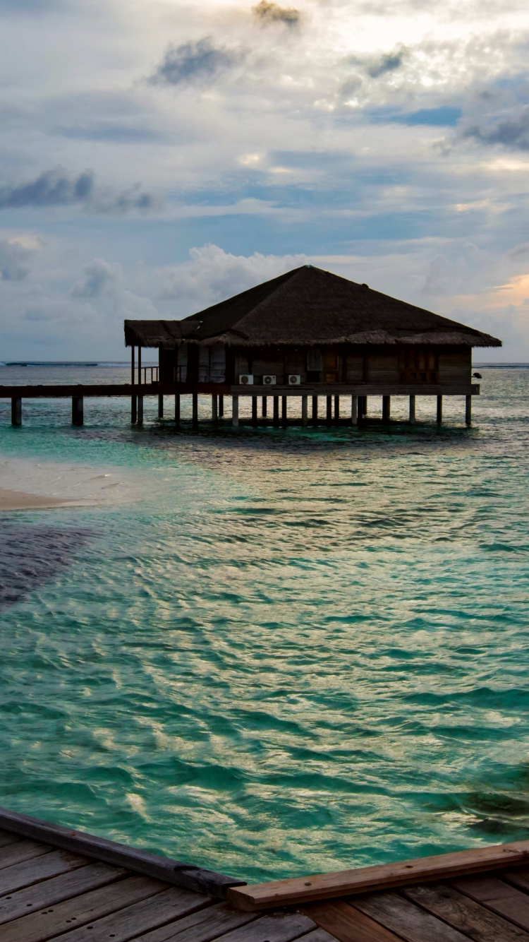 Brown Wooden Dock on Blue Sea Under Blue Sky During Daytime. Wallpaper in 750x1334 Resolution