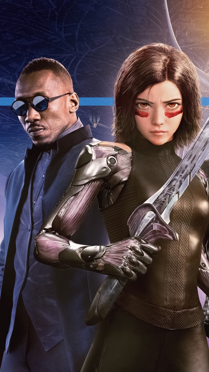 L'homme en Veste de Costume Noir Debout à Côté de la Femme en Manteau Marron. Wallpaper in 720x1280 Resolution