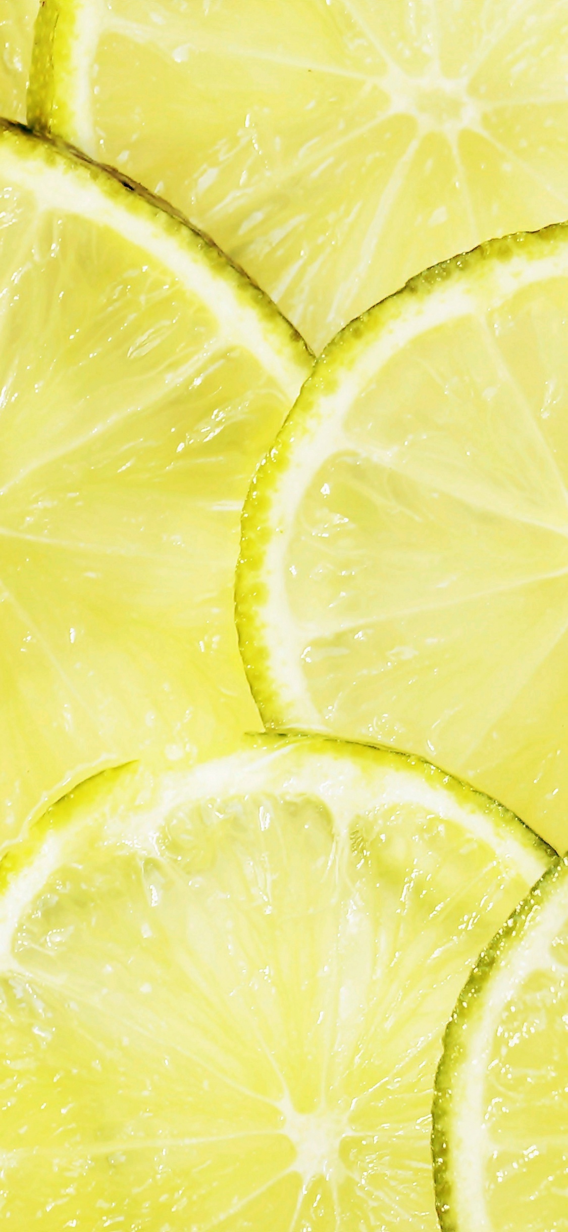 Yellow Lemon Fruit With Water Droplets. Wallpaper in 1125x2436 Resolution
