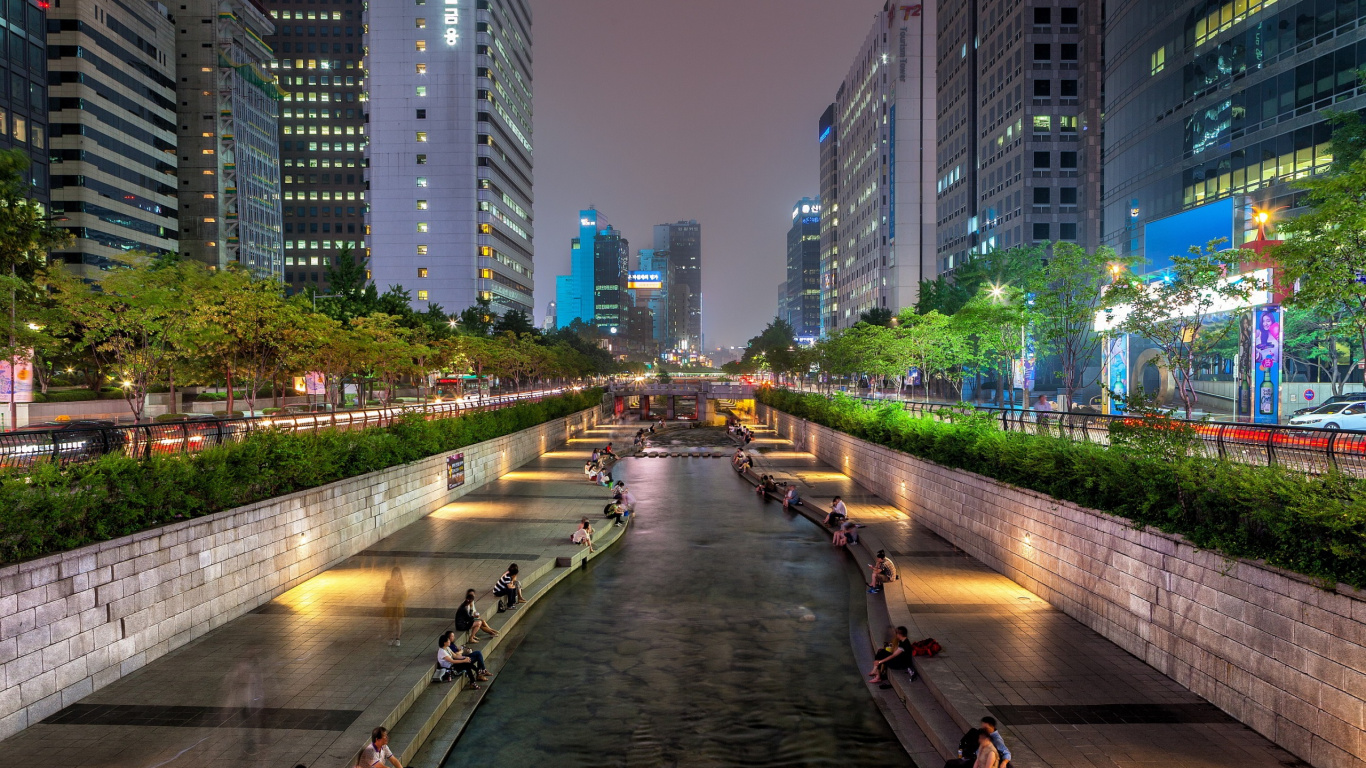 People Walking on Sidewalk Near High Rise Buildings During Night Time. Wallpaper in 1366x768 Resolution