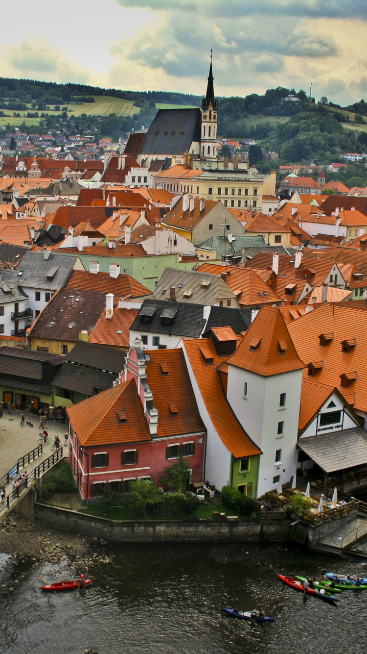 Brown and White Concrete Houses Beside River During Daytime. Wallpaper in 750x1334 Resolution