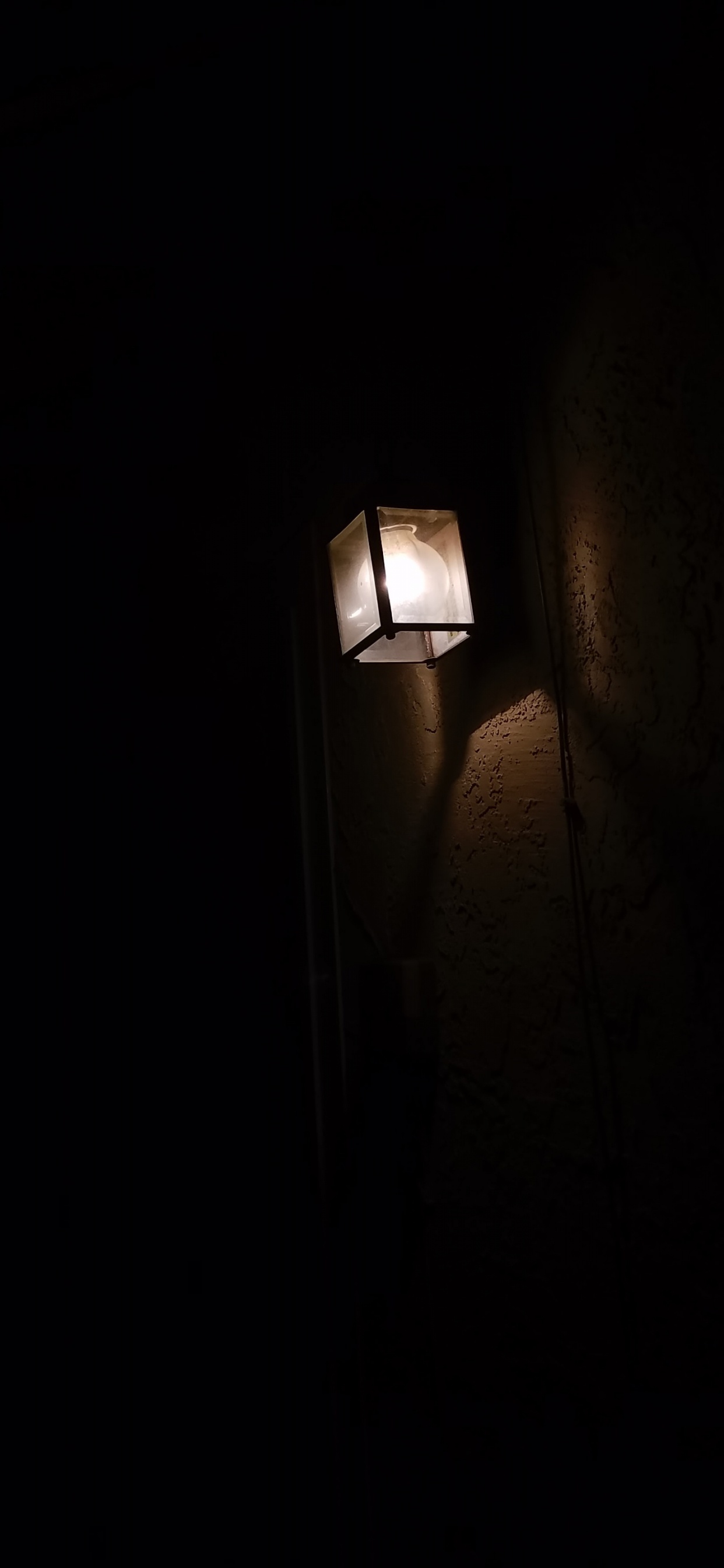 White Light Bulb Turned on in Dark Room. Wallpaper in 1242x2688 Resolution