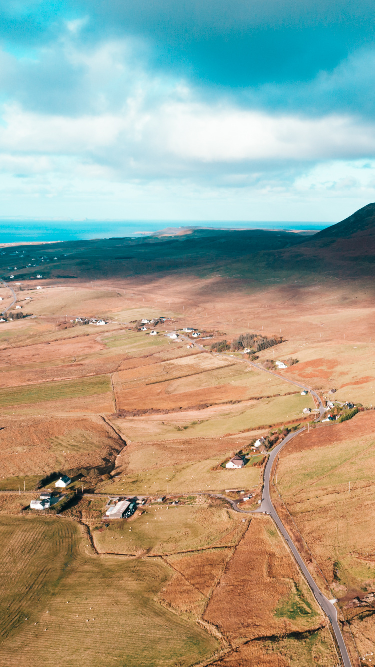 Brown Mountain Under Blue Sky During Daytime. Wallpaper in 750x1334 Resolution