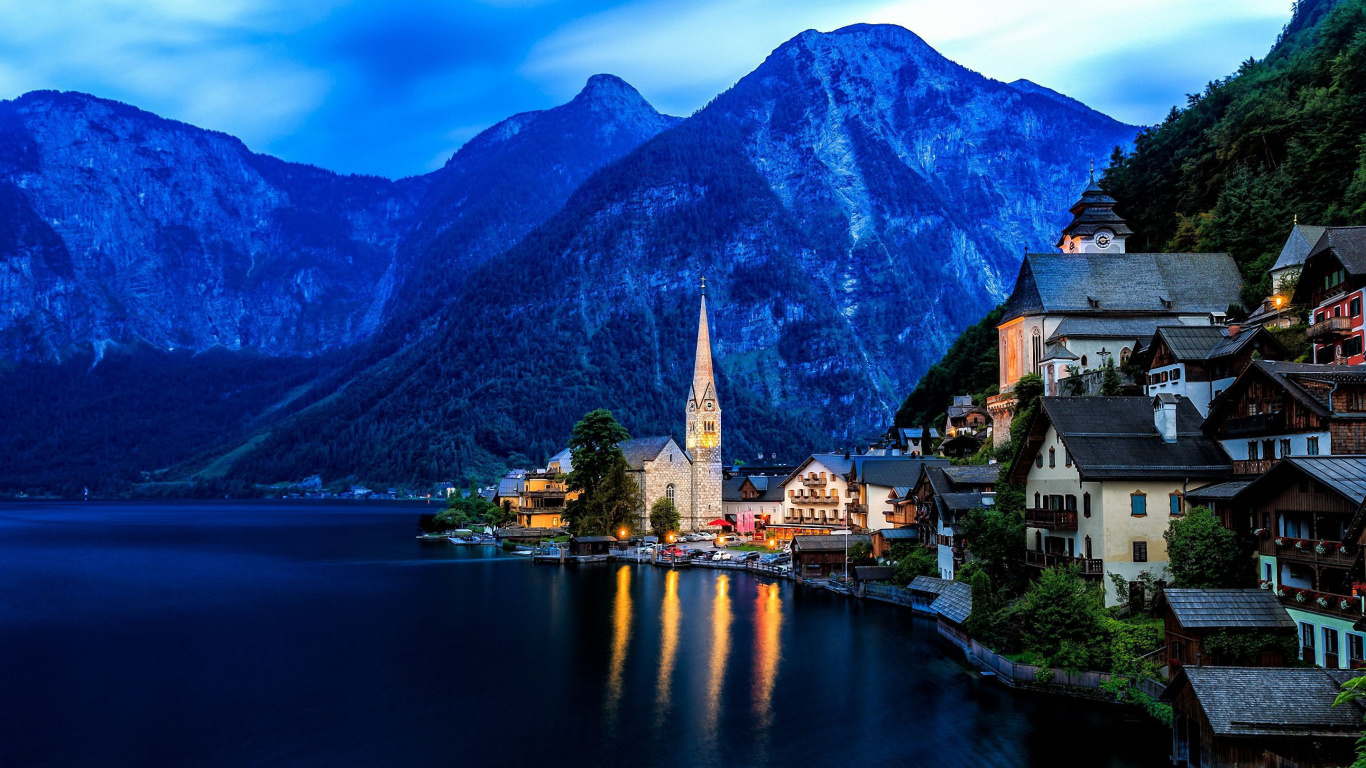 Brown and White Concrete Building Near Body of Water and Mountain During Daytime. Wallpaper in 1366x768 Resolution