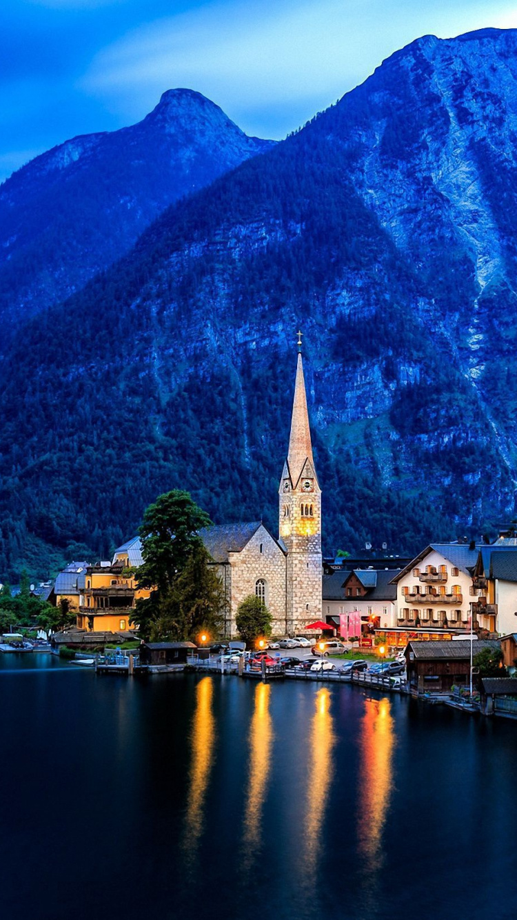 Brown and White Concrete Building Near Body of Water and Mountain During Daytime. Wallpaper in 750x1334 Resolution