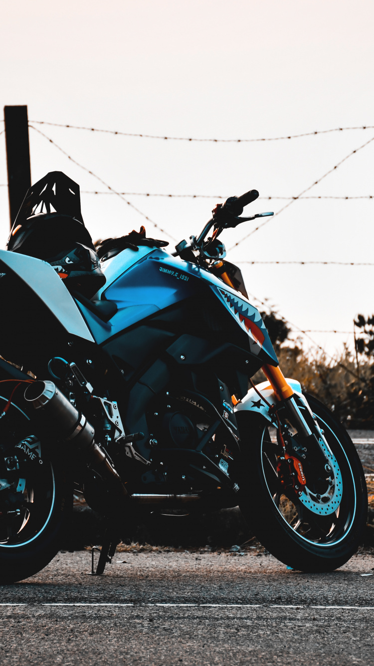 Black and Blue Sports Bike Parked on Gray Concrete Road During Daytime. Wallpaper in 750x1334 Resolution