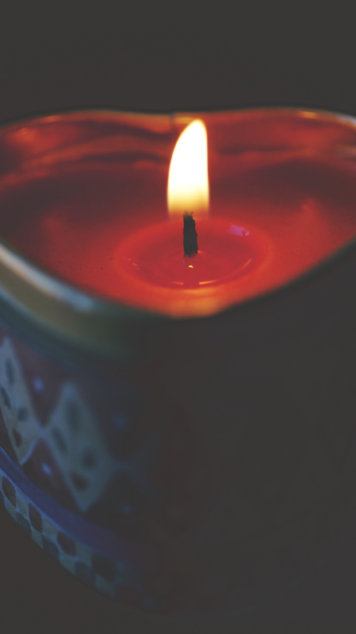 Red Lighted Candle on Blue Round Container. Wallpaper in 720x1280 Resolution