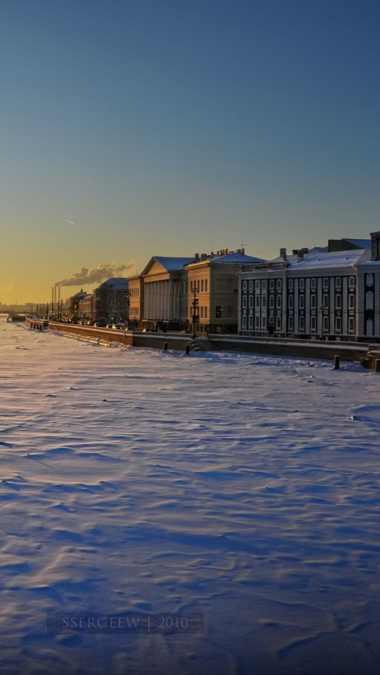White and Brown Concrete Building Near Body of Water During Sunset. Wallpaper in 750x1334 Resolution