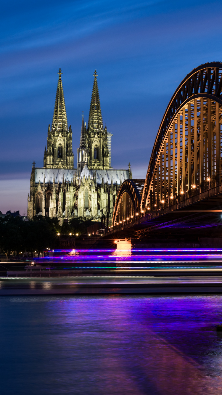 Bridge Over Body of Water During Night Time. Wallpaper in 750x1334 Resolution