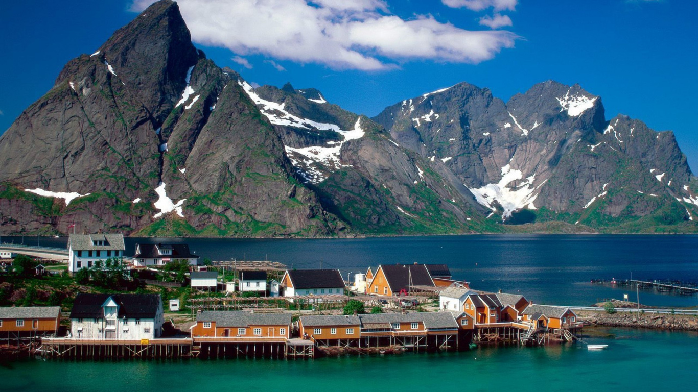 Brown Wooden Dock on Lake Near Snow Covered Mountain During Daytime. Wallpaper in 1366x768 Resolution
