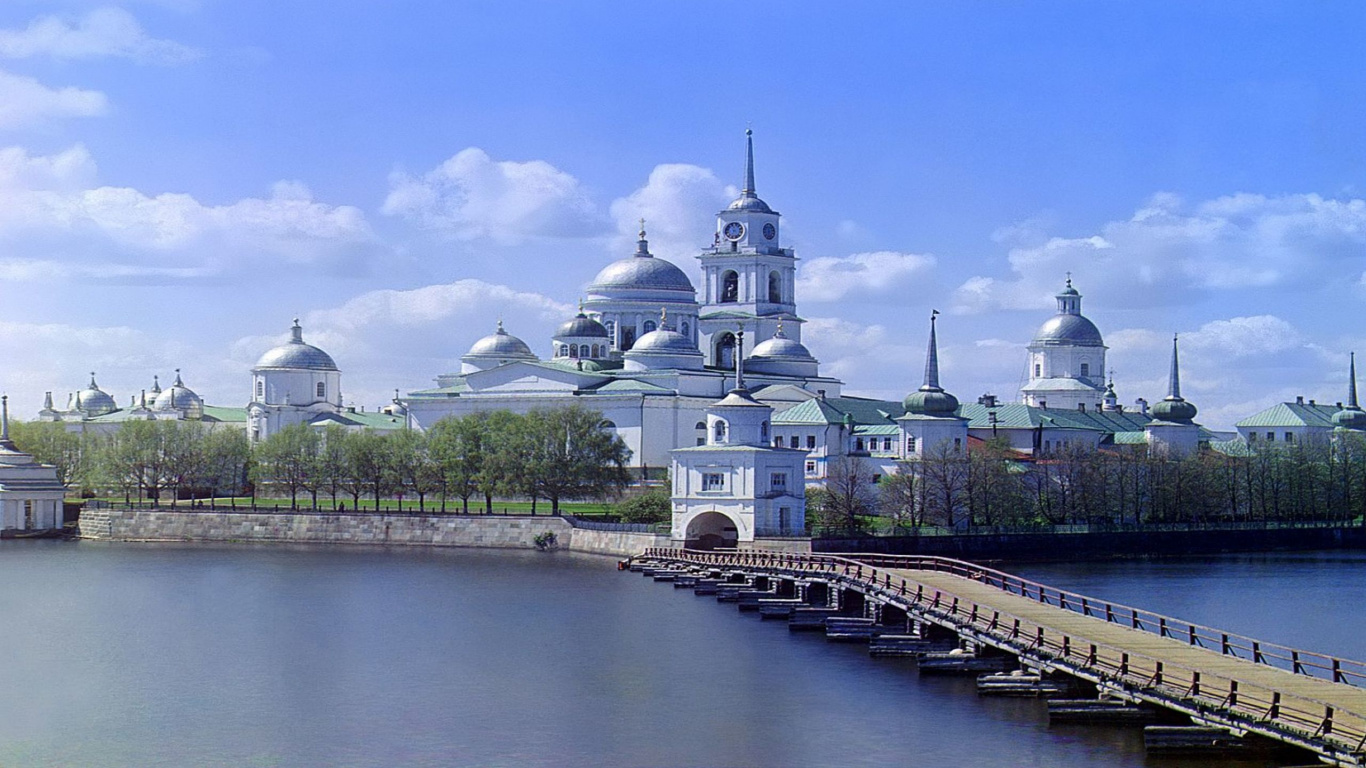 Weißes Und Braunes Betongebäude in Der Nähe Eines Gewässers Tagsüber. Wallpaper in 1366x768 Resolution