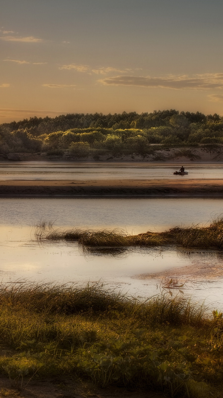 Green Grass Field Near Lake During Sunset. Wallpaper in 750x1334 Resolution