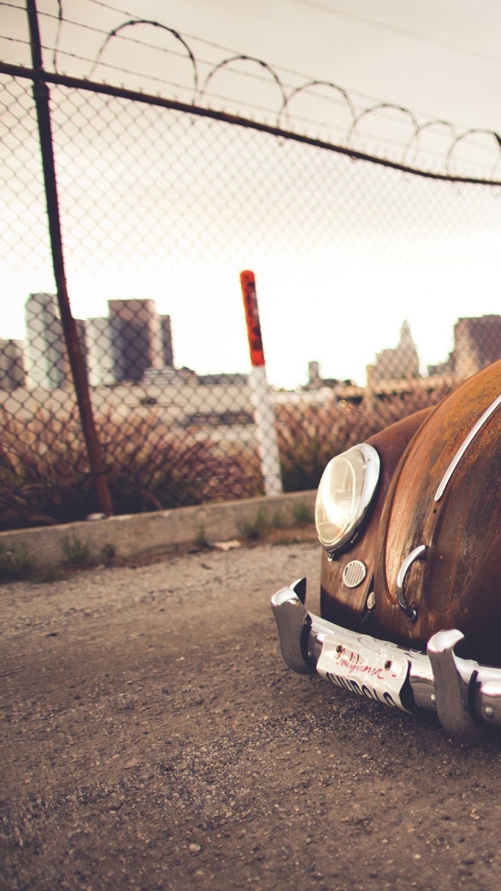 Brown Vintage Car on Gray Concrete Ground. Wallpaper in 720x1280 Resolution