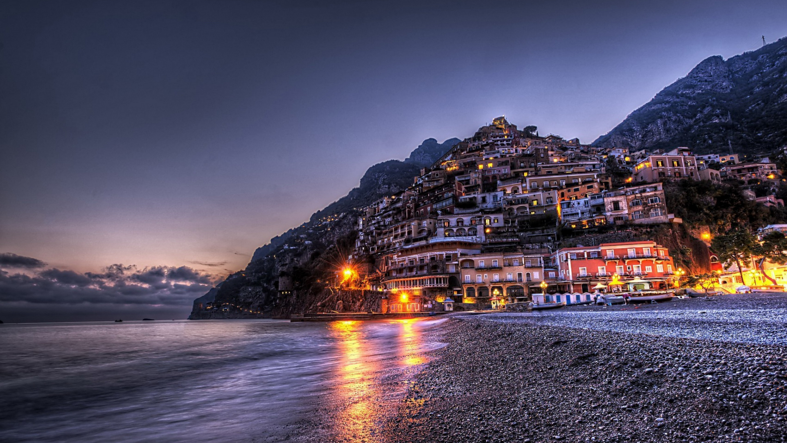 City Buildings Near Body of Water During Night Time. Wallpaper in 2560x1440 Resolution