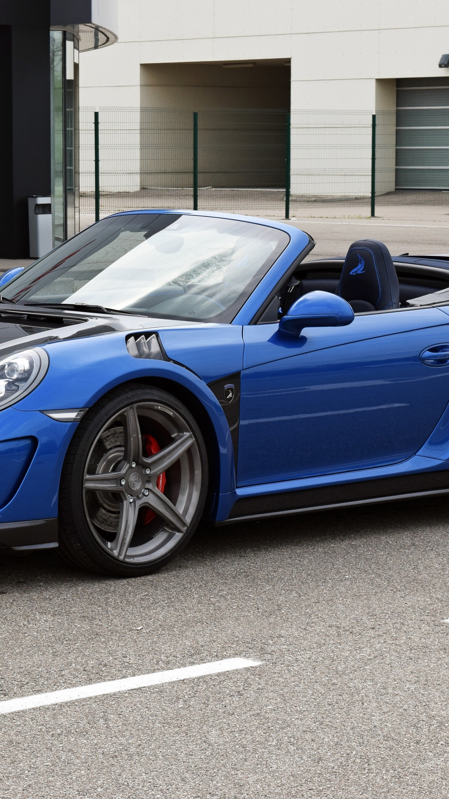 Blue Porsche 911 Parked Near Building During Daytime. Wallpaper in 1440x2560 Resolution