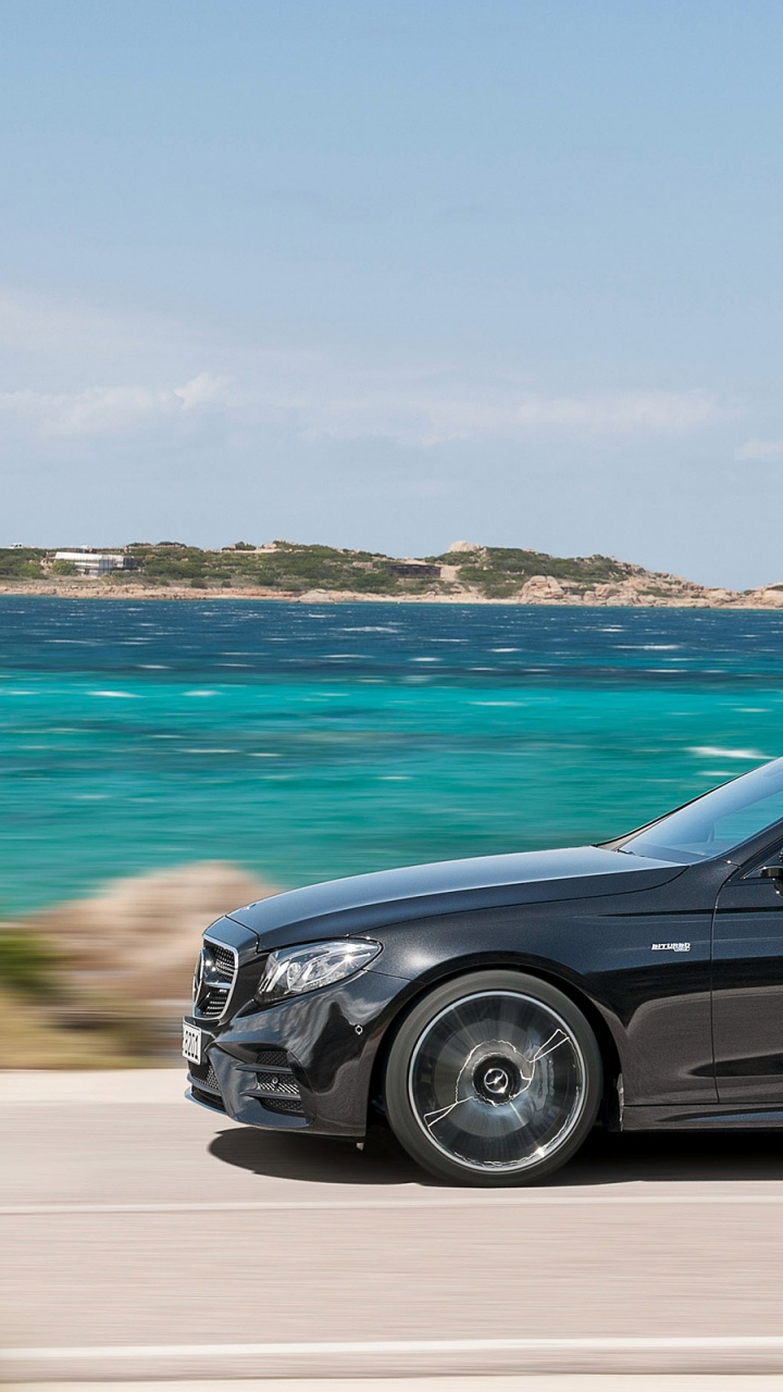 Black Suv on Brown Sand Near Body of Water During Daytime. Wallpaper in 720x1280 Resolution