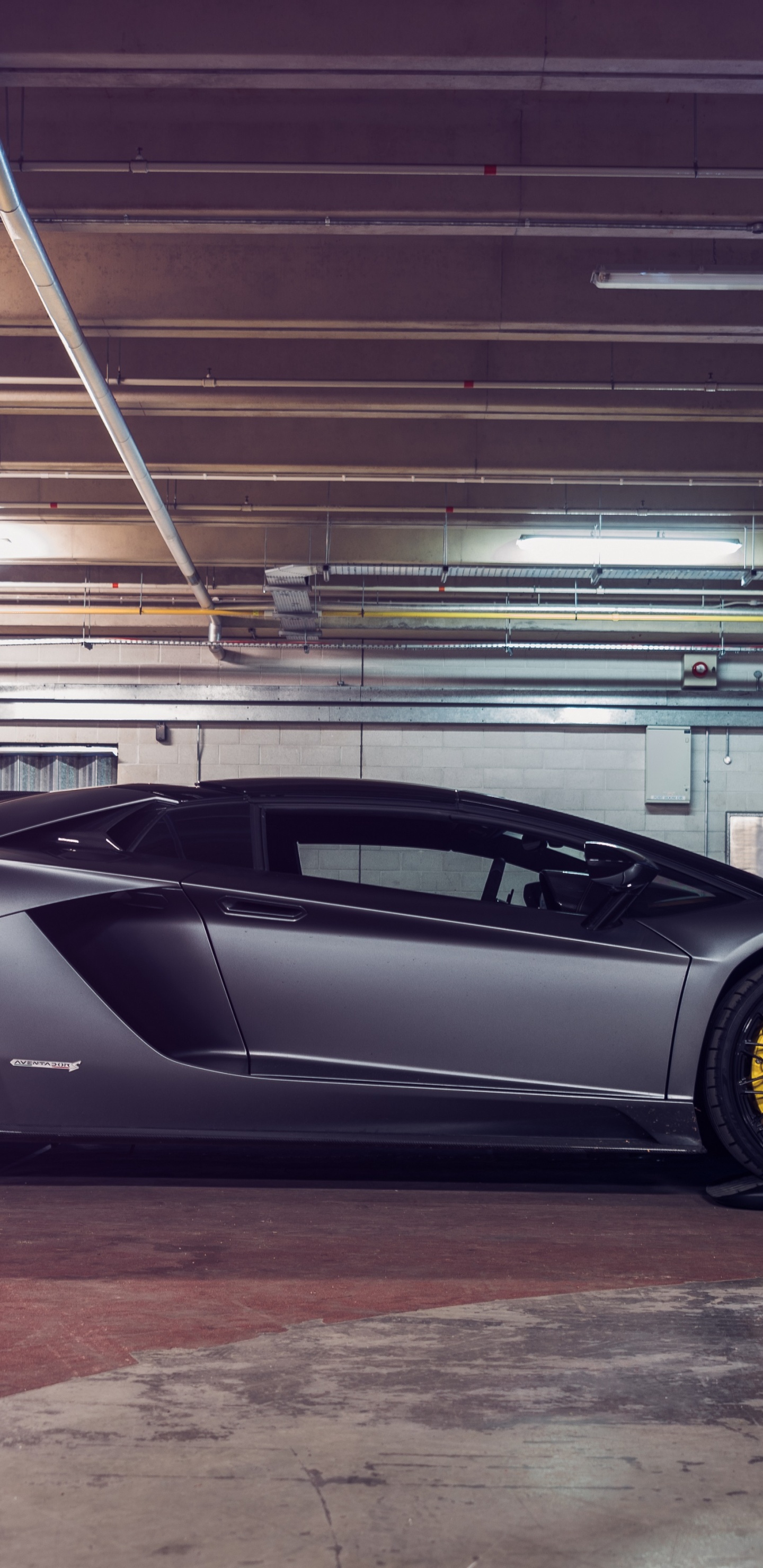Black Coupe Parked in a Parking Lot. Wallpaper in 1440x2960 Resolution
