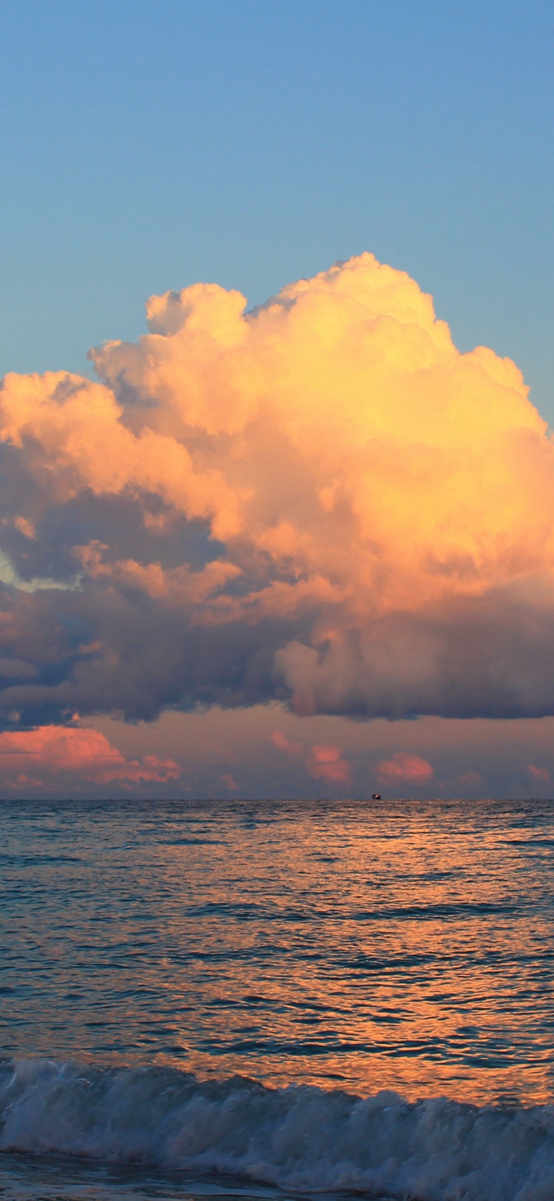 Sea Waves Crashing on Shore During Sunset. Wallpaper in 1125x2436 Resolution