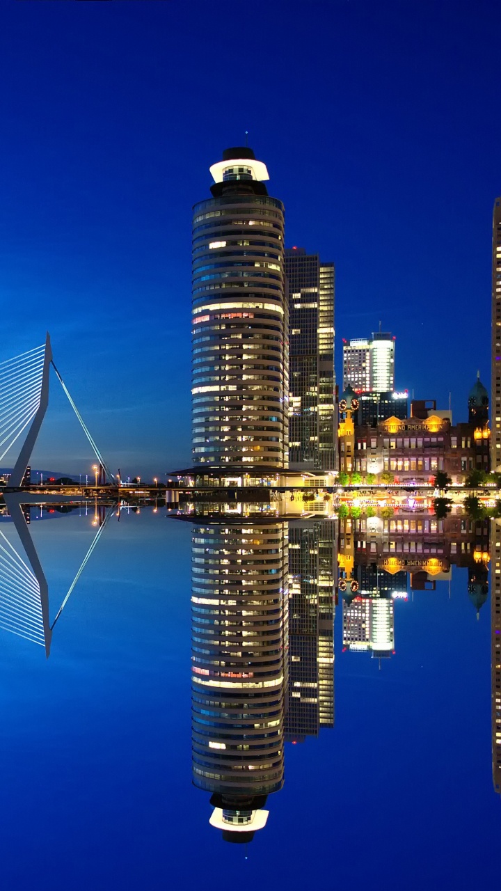 Bridge Over Water Near City Buildings During Night Time. Wallpaper in 720x1280 Resolution