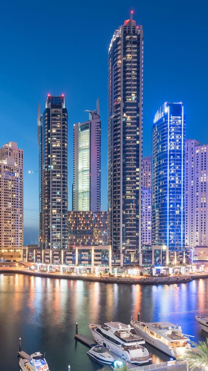 City Skyline Across Body of Water During Night Time. Wallpaper in 720x1280 Resolution