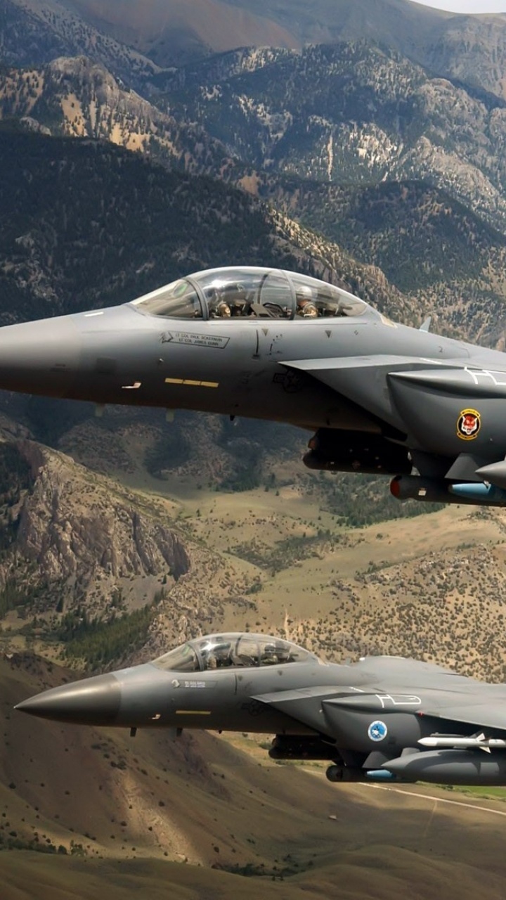 Avión de Combate Negro Volando Sobre Las Montañas Durante el Día. Wallpaper in 720x1280 Resolution