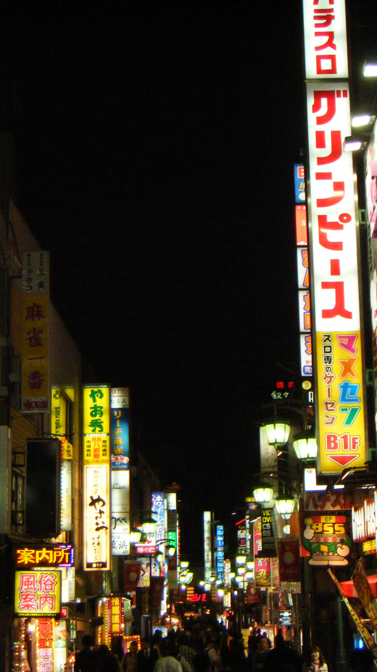 People Walking on Street During Nighttime. Wallpaper in 750x1334 Resolution