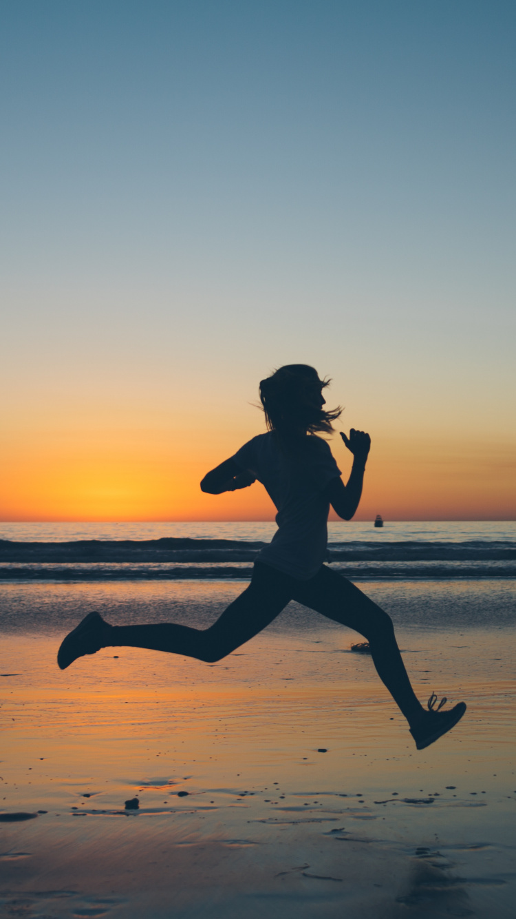 Silhouette of Man Jumping on Beach During Sunset. Wallpaper in 750x1334 Resolution