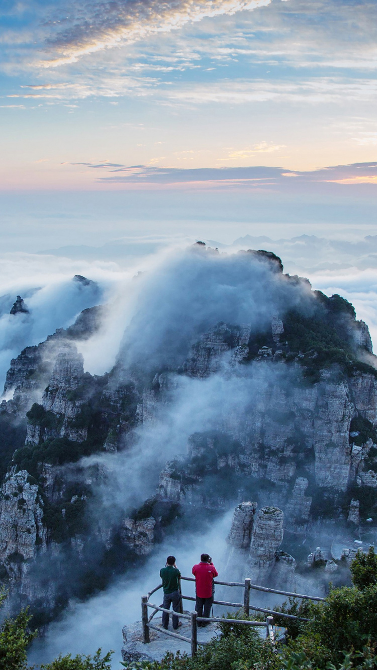 Person Standing on Top of Mountain During Daytime. Wallpaper in 750x1334 Resolution