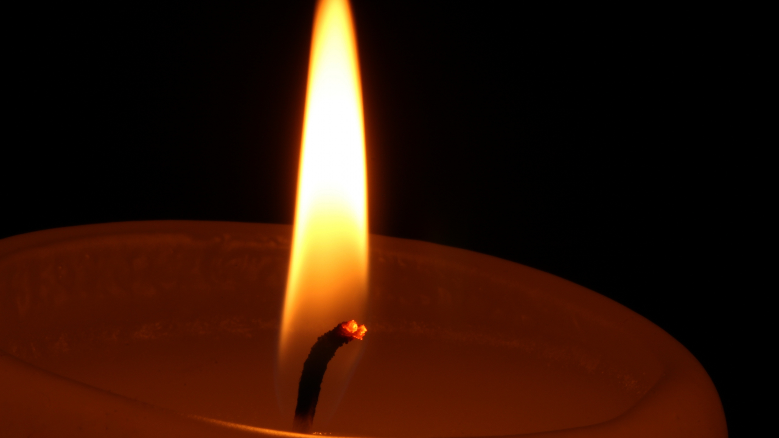 Lighted Candle in Dark Room. Wallpaper in 2560x1440 Resolution