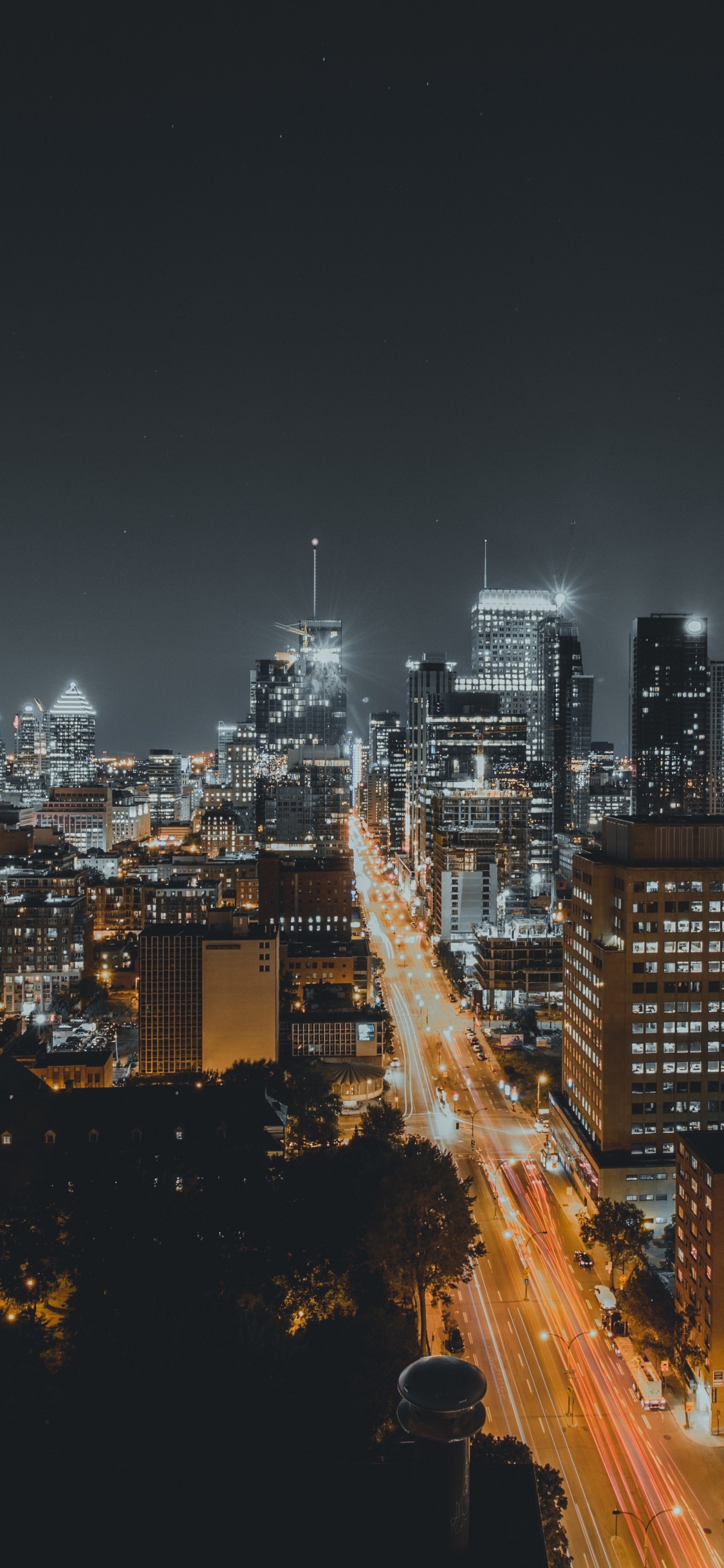 Aerial View of City Buildings During Night Time. Wallpaper in 1125x2436 Resolution