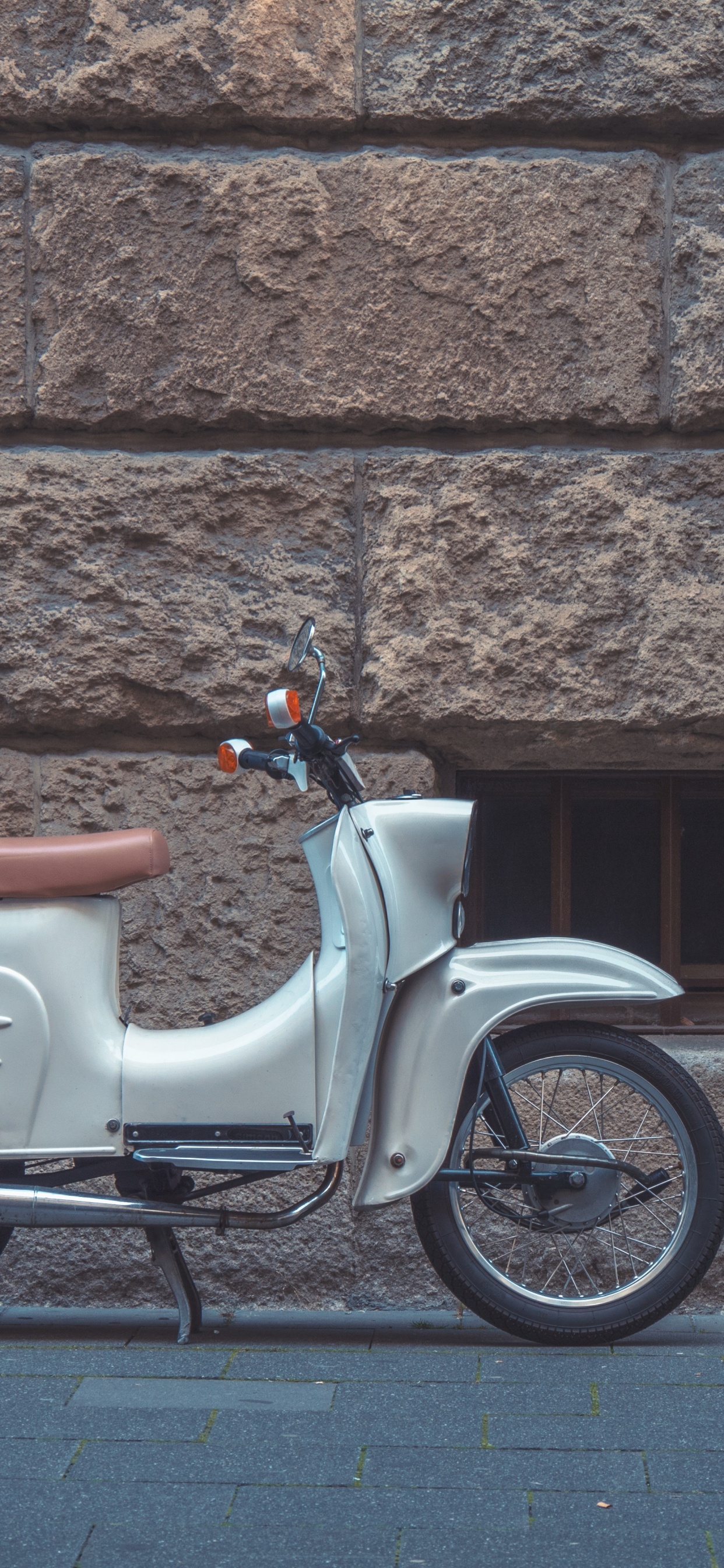 White and Brown Motor Scooter Parked Beside Brown Brick Wall. Wallpaper in 1242x2688 Resolution