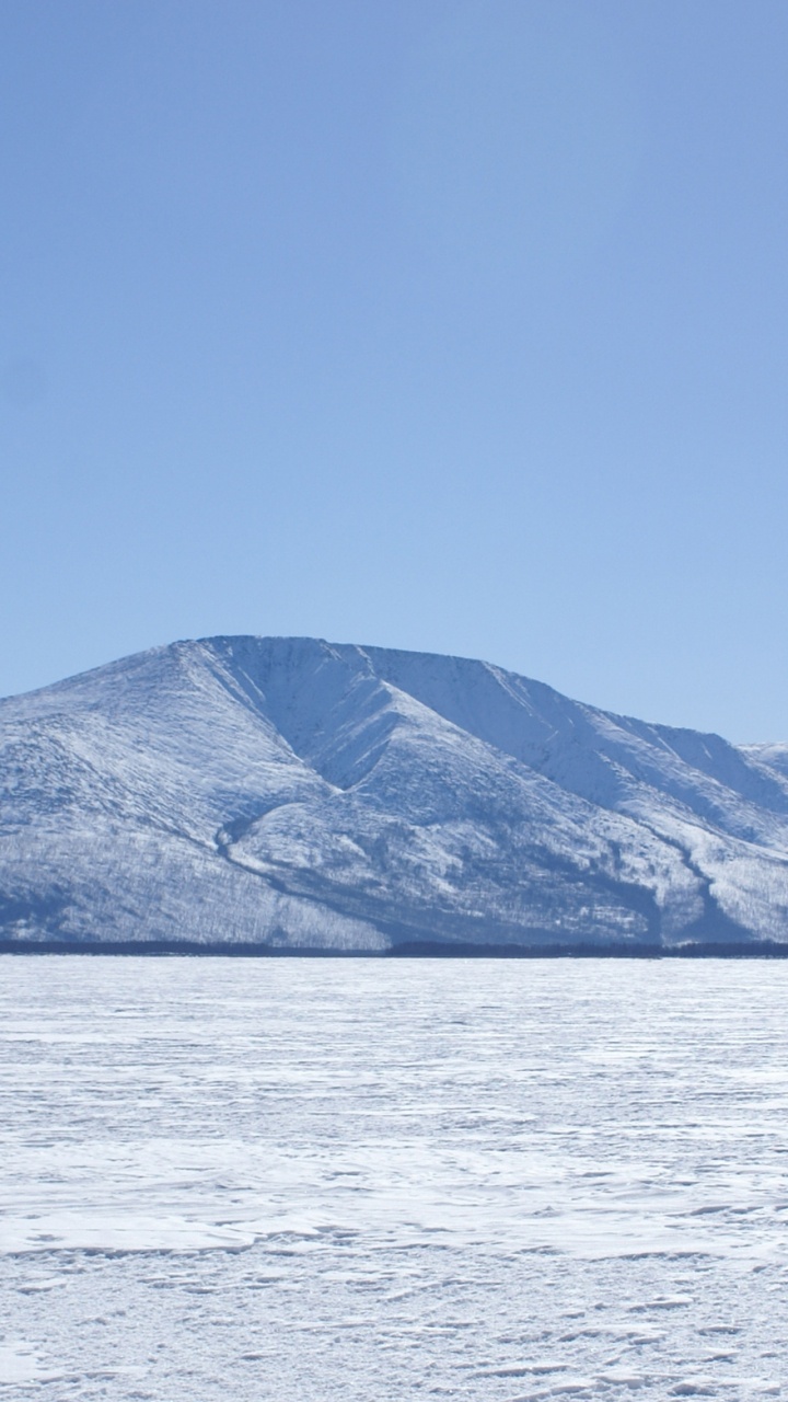 Person Standing on Dock Near Snow Covered Mountain During Daytime. Wallpaper in 720x1280 Resolution